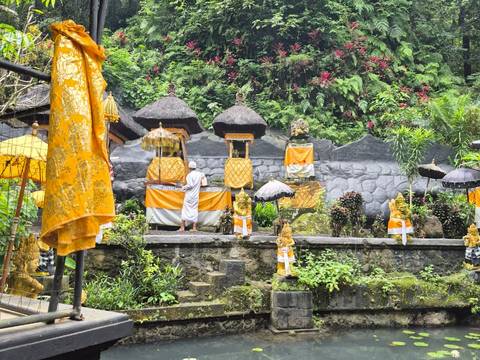 A spring-fed water temple in east Bali dressed in yellow cloth for a ceremony.